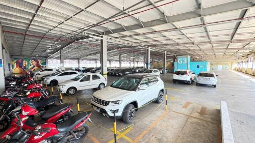 a garage with cars and motorcycles parked in it at Mega Moda Goiania Hotel in Goiânia