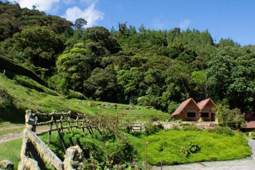 a farm with a house on a hill at TREE TREK BOQUETE Adventure Park in Boquete