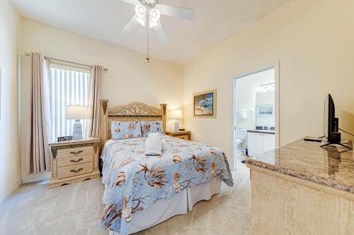 a bedroom with a bed and a dresser and a television at Tuscan Pines Villa in Davenport