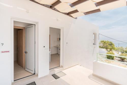 a room with white walls and a large window at CrossRhodes Villas in Pefki Rhodes