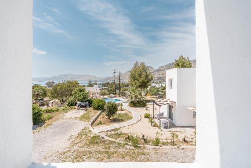 an aerial view of a white house with a driveway at CrossRhodes Villas in Pefki Rhodes