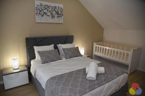 a bedroom with a large bed with white sheets and pillows at House Vila Santa Ana in Santana