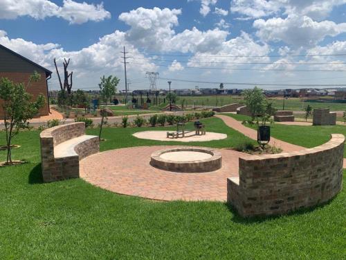 a park with a bench and a stone wall at Views at Schoeman in Sandton