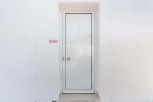 a white door with a sign on it at CrossRhodes Villas in Pefki Rhodes