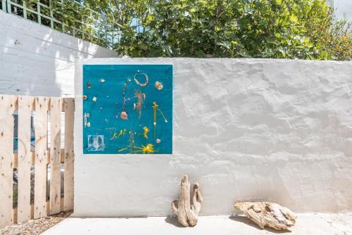 a painting of flowers on a wall next to a fence at CrossRhodes Villas in Pefki Rhodes