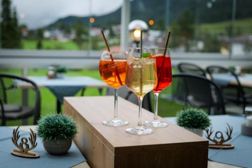 two glasses of wine sitting on a table at Pension Posthansl in Heiterwang