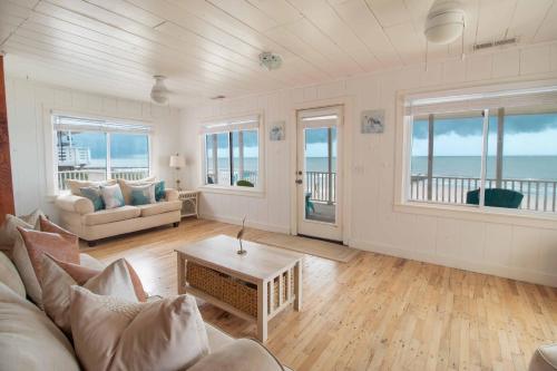 a living room with a couch and a table at Barefoot Bungalow in Edisto Island