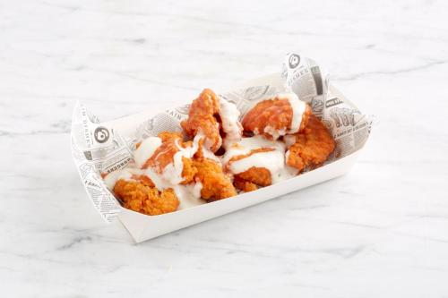 a container of food with chicken nuggets at Holiday Inn Runcorn M56 Junction 12 by IHG in Runcorn