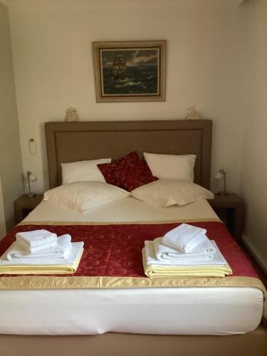 a bed with two towels on top of it at Bed and Breakfast Villa Iris in Mošćenička Draga
