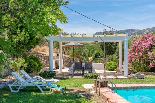 a backyard with a pool and a gazebo at Casa Rural Molino Macegal new in Carcabuey