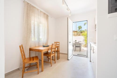 a kitchen and dining room with a table and chairs at CrossRhodes Villas in Pefki Rhodes