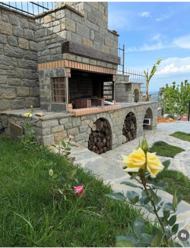 an outdoor pizza oven in a yard with grass at Sunrise House - Swimming Pool in Berat