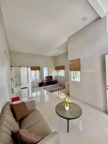 a living room with a couch and a table at Villa Sultana Malang in Malang