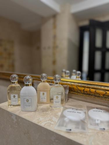 a group of bottles on a counter in front of a mirror at CH Exclusive Copou in Iaşi