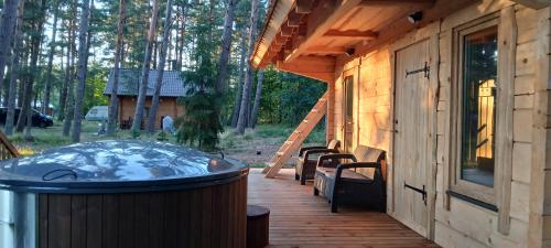 a hot tub on a deck next to a house at Karu Rannamaja in Tahkuranna