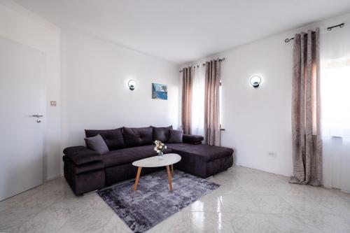 a living room with a couch and a table at Villa Belvue - Big Pool & Private Parking - 500m Sea in Medulin
