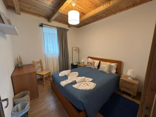 a bedroom with a bed with towels on it at Casa do Branco in Faja Grande