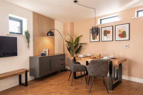 a dining room with a table and chairs at Boat House - Luxe Apt with River View - Next to Harbour & Cafes in Bristol