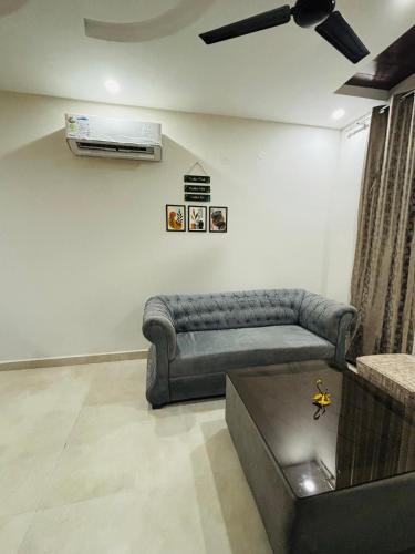 a living room with a couch and a fan at 4BHK Luxury Villa In Mohali - Stay Royal in Kharar