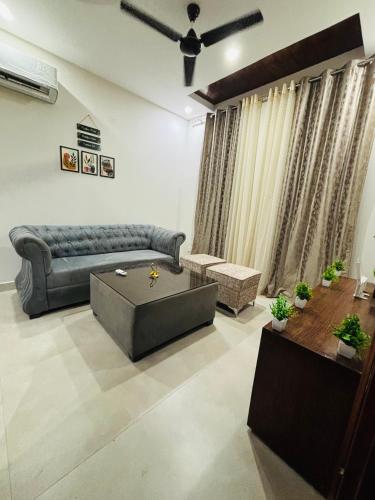 a living room with a couch and a coffee table at 4BHK Luxury Villa In Mohali - Stay Royal in Kharar