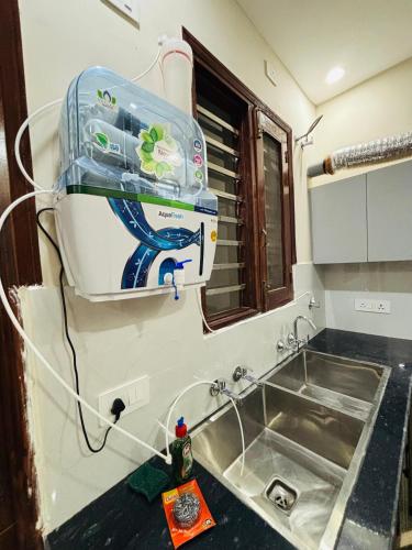 a kitchen sink with a toaster on the wall at 4BHK Luxury Villa In Mohali - Stay Royal in Kharar