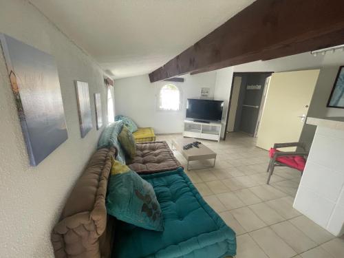 un salon avec un canapé et une télévision dans l'établissement 65m2- 2 chambres parentales - 4 pers, à Vic-la-Gardiole