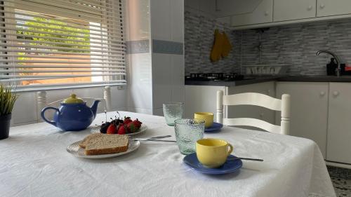 a table with a plate of food and two cups on it at Amanecer Combarro in Combarro