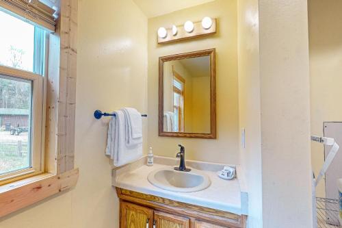 a bathroom with a sink and a mirror at The View on Found Lake in Saint Germain