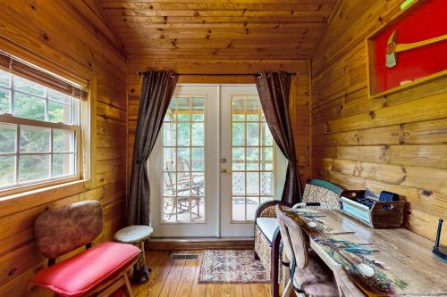 a log cabin living room with a table and chairs at Rustic Getaway in Topton
