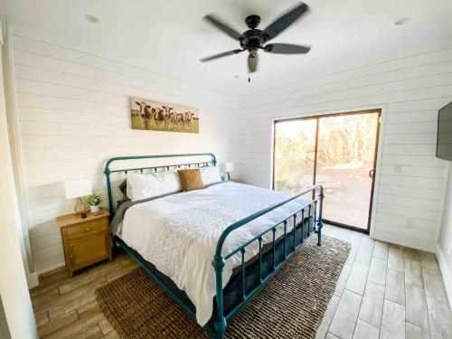 a bedroom with a bed and a ceiling fan at The Phoenix Farmhouse in Phoenix