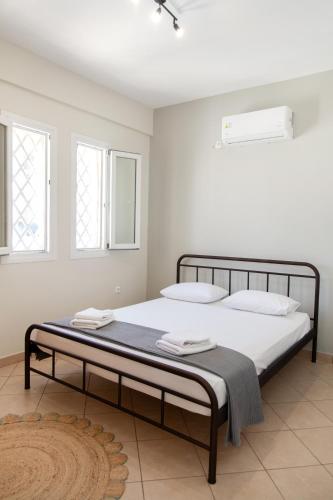 a bedroom with a large bed with white walls at Casa Chora by Sea ALure in Tinos