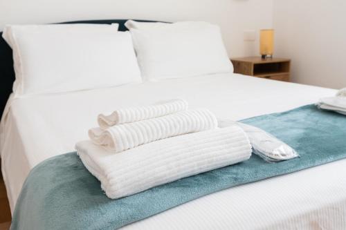 two towels are stacked on top of a bed at Vatican - Casa Cesarina in Rome