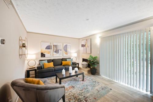 a living room with a couch and a table at King Bed 5 min walk Truist Park The Battery in Atlanta