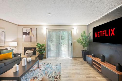 a living room with a netflix sign on the wall at King Bed 5 min walk Truist Park The Battery in Atlanta