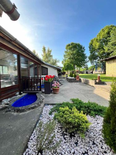 a yard with a house with a blue pond at Pool House in Subotica
