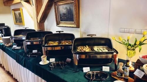 a table with three trays of food on it at Hotel Spichrz in Borcz