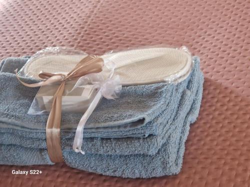 a pair of towels with a ribbon on them at Linda's Retreat in Fiano Romano