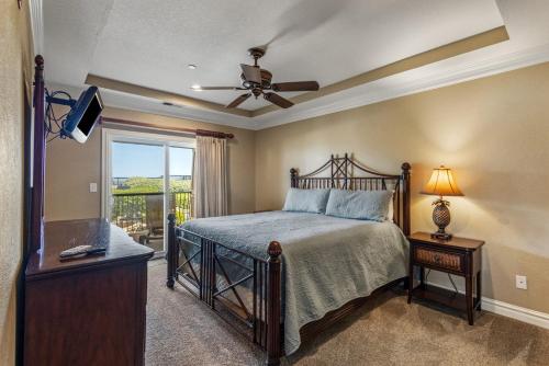 a bedroom with a bed and a ceiling fan at CSC2R - Dolphins Den in Kill Devil Hills