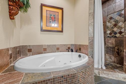 a bath tub in a bathroom with a shower at CSC2R - Dolphins Den in Kill Devil Hills