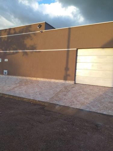 un edificio con dos puertas de garaje a un lado en Aluguel de um quarto - Espaço Maranata, en Porangatu