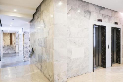 a large stone wall in a hallway with a door at The FLOOR in Milan