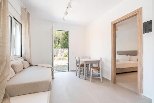a room with a bed and a table and a mirror at CrossRhodes Villas in Pefki Rhodes