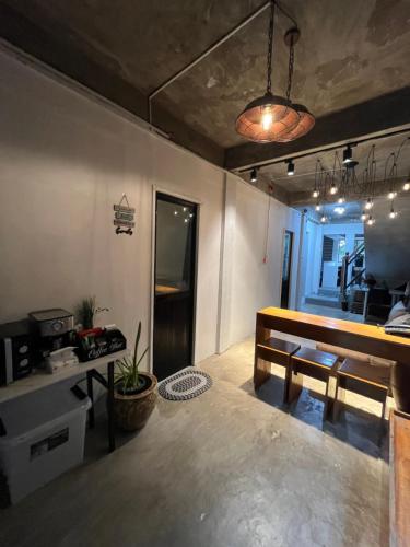 a living room with a bench and a table at Stayzy Pagadian 