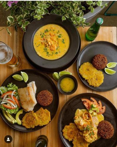 a wooden table with plates of food on it at Coco Beach Cartagena in Cartagena de Indias