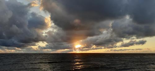 a stormy sky over the ocean with a rainbow at Karu Rannamaja in Tahkuranna