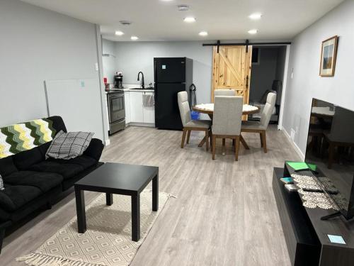 a living room with a couch and a table at Gorgeous Basement Apartment in Calgary