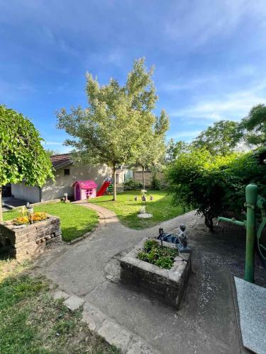 a backyard with a garden with a fountain at Pool House in Subotica
