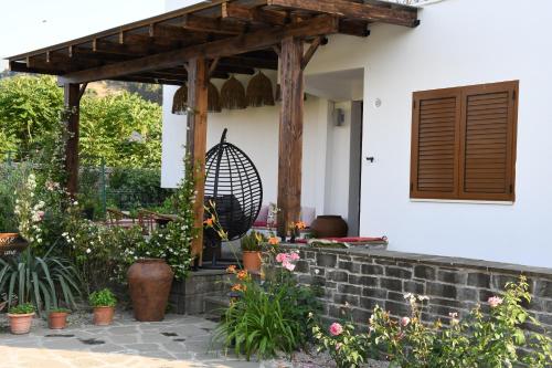 a porch of a house with a wooden pergola at GuestHouse "Shtëpia ime" in Përmet