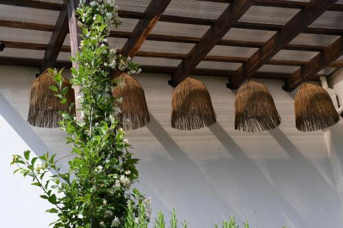 a group of straw hats hanging from a ceiling at GuestHouse "Shtëpia ime" in Përmet