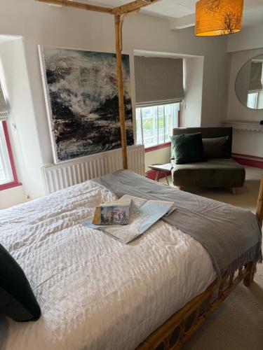 a bedroom with a bed and a couch at St Davids Art House in St. Davids